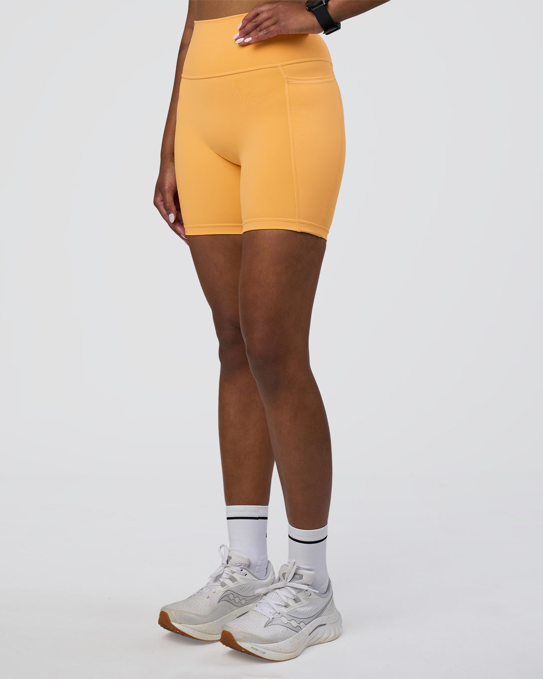 Woman wearing Fusion Ultra High-Rise 6&quot; Short Pockets - Warm Apricot | Model:Rica | Size:S