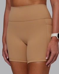 Woman wearing Fusion Ultra High-Rise 6" Short Pockets - Warm Smoke | Model:Phoebe | Size:S
