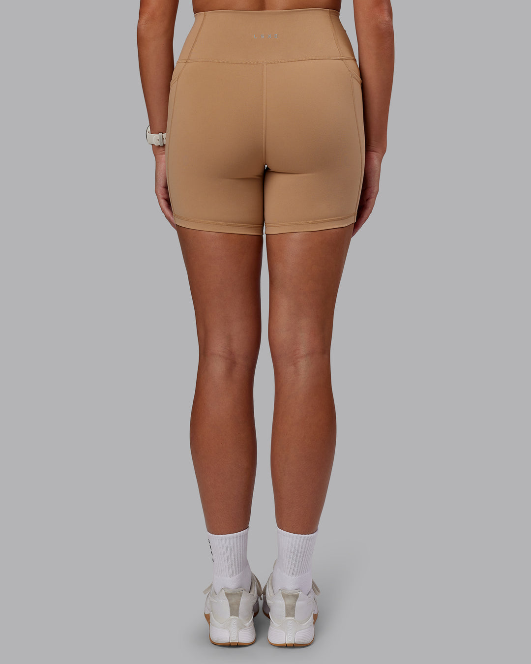 Woman wearing Fusion Ultra High-Rise 6&quot; Short Pockets - Warm Smoke | Model:Phoebe | Size:S