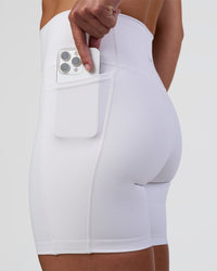 Woman wearing Fusion Ultra High-Rise 6" Short Pockets - White | Set:true | Angle:closeup | Model:Sav | Size:S