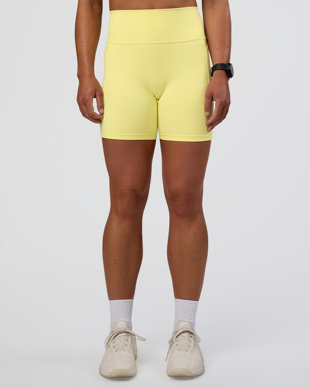 Woman wearing Fusion Ultra High-Rise 6" Short Pockets - Yellow Fizz | Model:Sav | Size:S