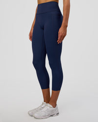 Woman wearing Fusion Ultra High-Rise 7/8 Legging Pockets - Future Navy | Model:Evie | Size:S