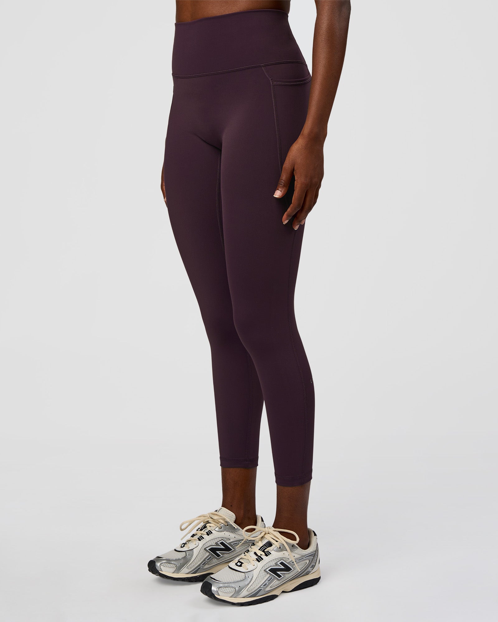 Woman wearing Fusion Ultra High-Rise 7/8 Legging Pockets - Midnight Plum | Model:Ellie | Size:S