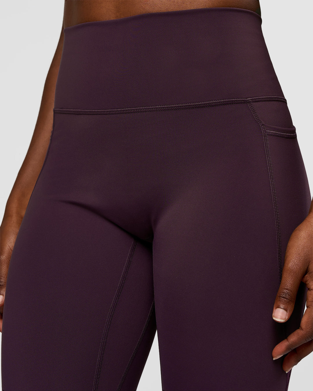 Woman wearing Fusion Ultra High-Rise 7/8 Legging Pockets - Midnight Plum | Model:Ellie | Size:S