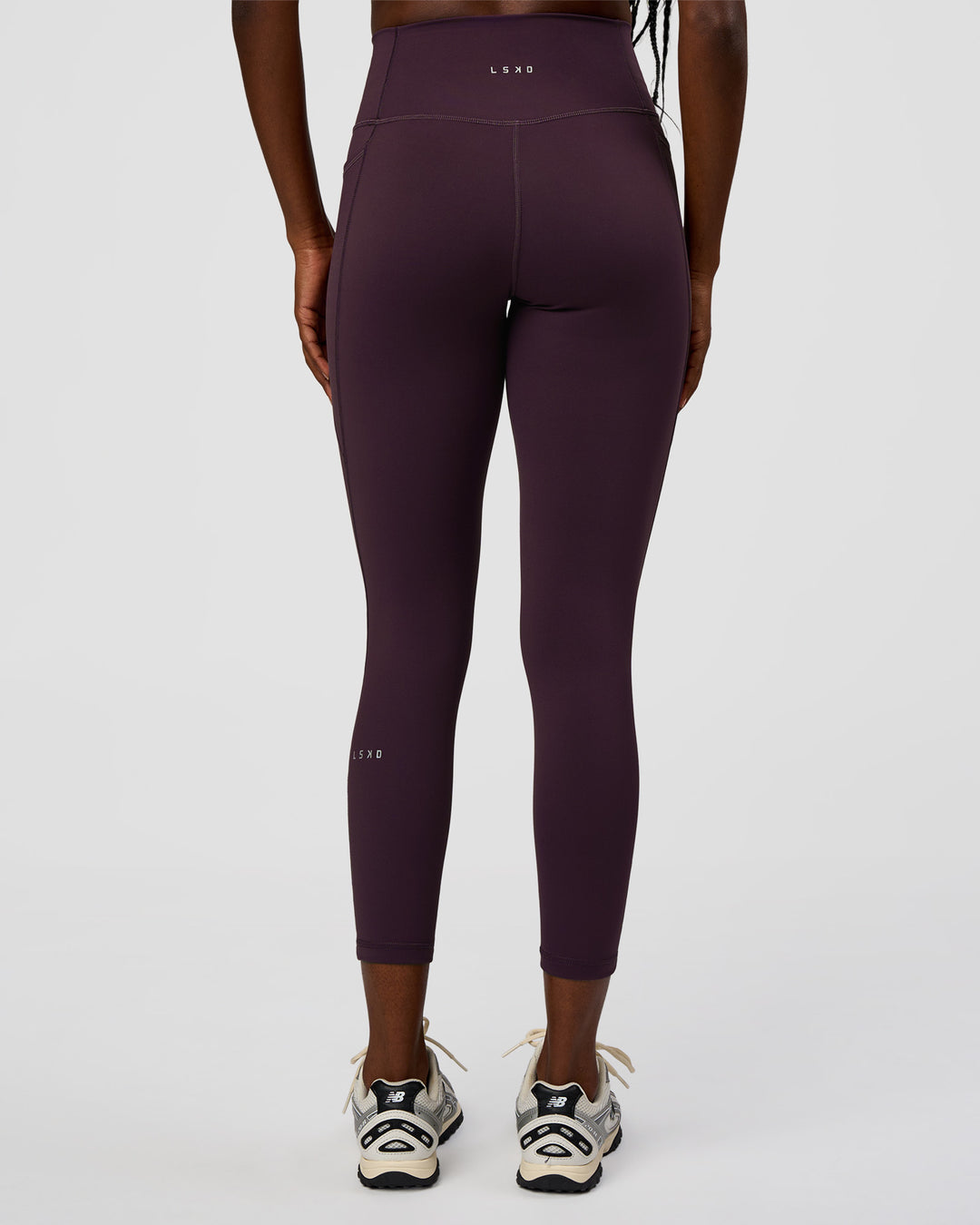 Woman wearing Fusion Ultra High-Rise 7/8 Legging Pockets - Midnight Plum | Model:Ellie | Size:S