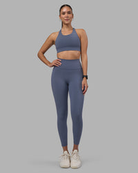 Woman wearing Fusion Ultra High-Rise 7/8 Legging Pockets - Night Shadow | Model:Rhiley | Size:S