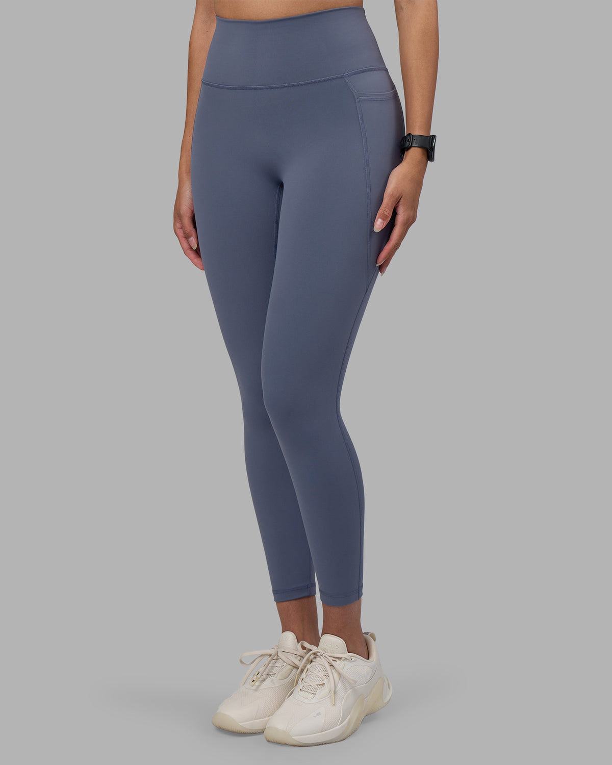Woman wearing Fusion Ultra High-Rise 7/8 Legging Pockets - Night Shadow | Model:Rhiley | Size:S