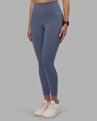 Woman wearing Fusion Ultra High-Rise 7/8 Legging Pockets - Night Shadow | Model:Rhiley | Size:S