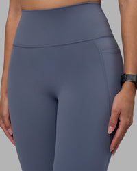 Woman wearing Fusion Ultra High-Rise 7/8 Legging Pockets - Night Shadow | Model:Rhiley | Size:S