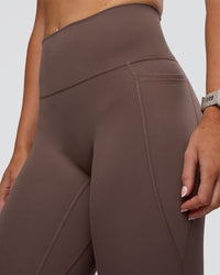 Woman wearing Fusion Ultra High-Rise 7/8 Legging Pockets - Peppercorn | Model:Emelia | Size:S