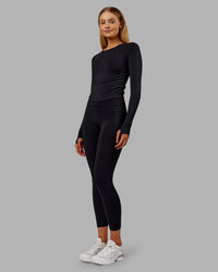 Woman wearing Fusion Ultra High-Rise 7/8 Thermal Legging Pockets - Black | Model:Ella | Size:S