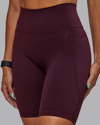 Woman wearing Fusion Ultra High-Rise 9" Short Pockets - Cherry Lacquer | Model:Vanessa | Size:S