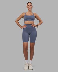 Woman wearing Fusion Ultra High-Rise 9" Short Pockets - Night Shadow | Model:Rhiley | Size:S