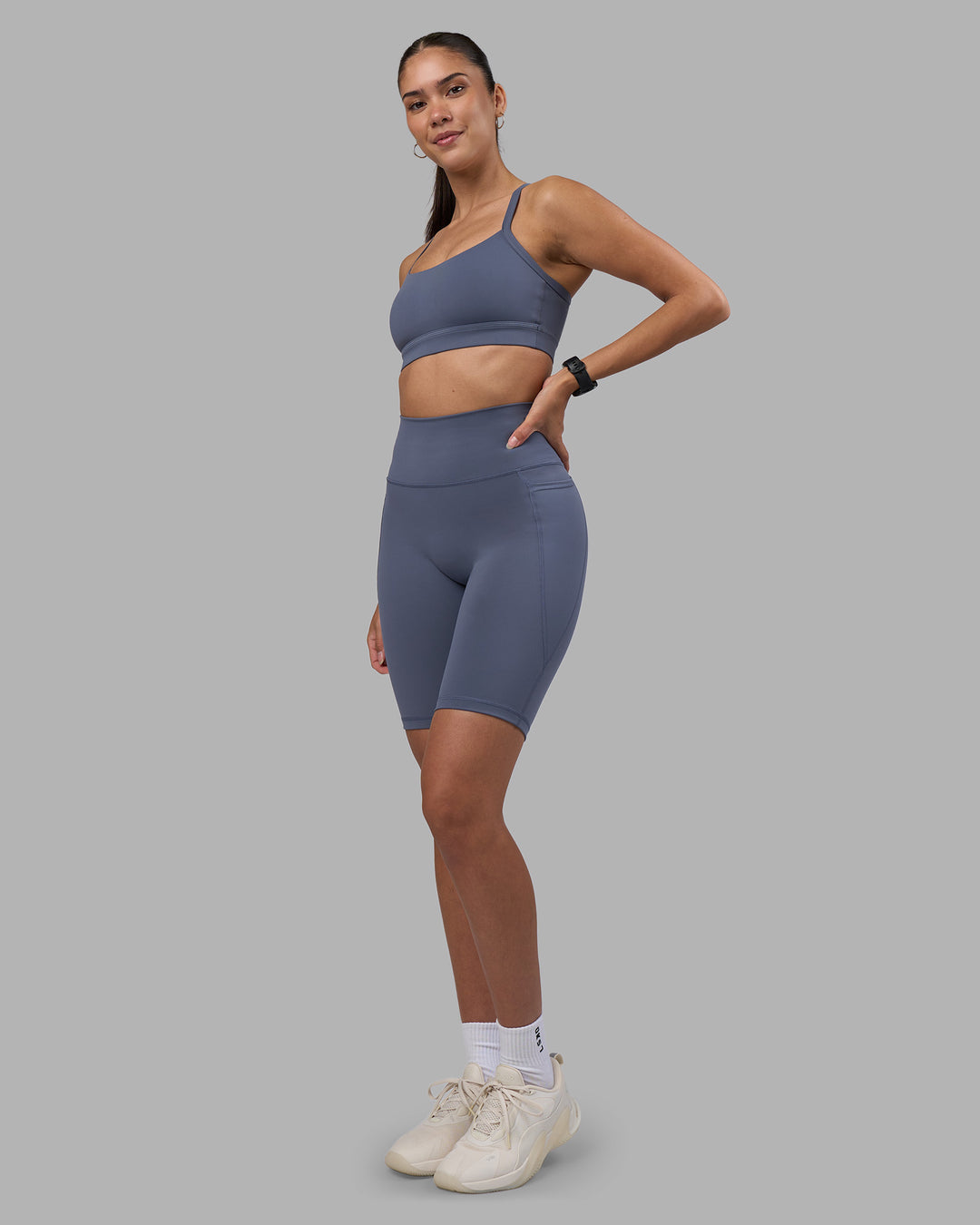 Woman wearing Fusion Ultra High-Rise 9&quot; Short Pockets - Night Shadow | Model:Rhiley | Size:S