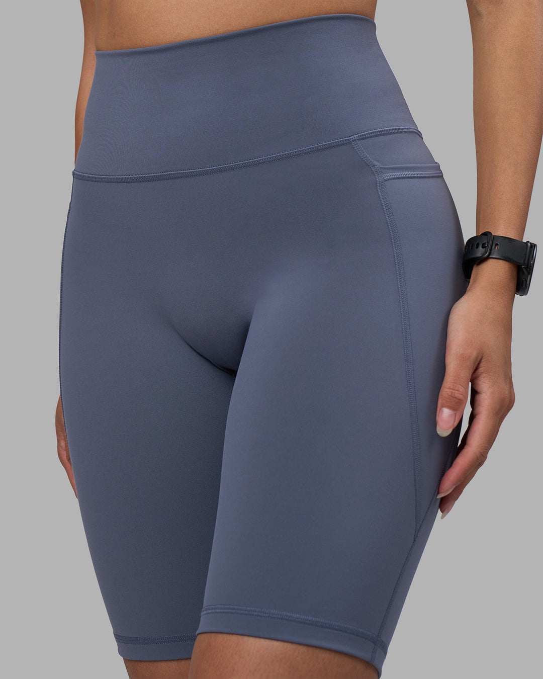Woman wearing Fusion Ultra High-Rise 9&quot; Short Pockets - Night Shadow | Model:Rhiley | Size:S