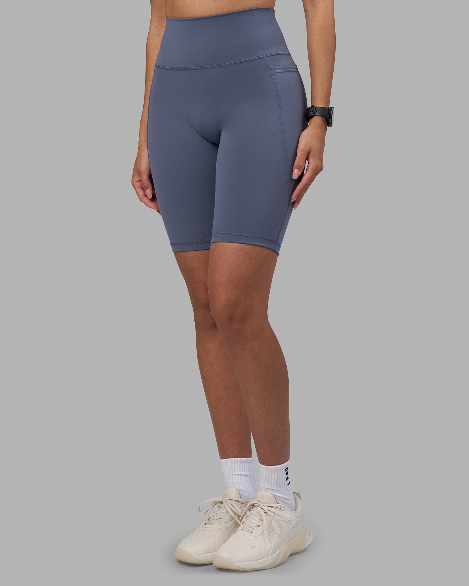 Woman wearing Fusion Ultra High-Rise 9" Short Pockets - Night Shadow | Model:Rhiley | Size:S