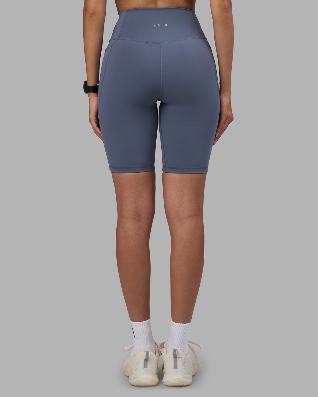 Woman wearing Fusion Ultra High-Rise 9&quot; Short Pockets - Night Shadow | Model:Rhiley | Size:S