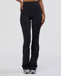 Woman wearing Fusion Ultra High-Rise Flared Tall Legging Pockets - Black | Model:Tomi | Size:S