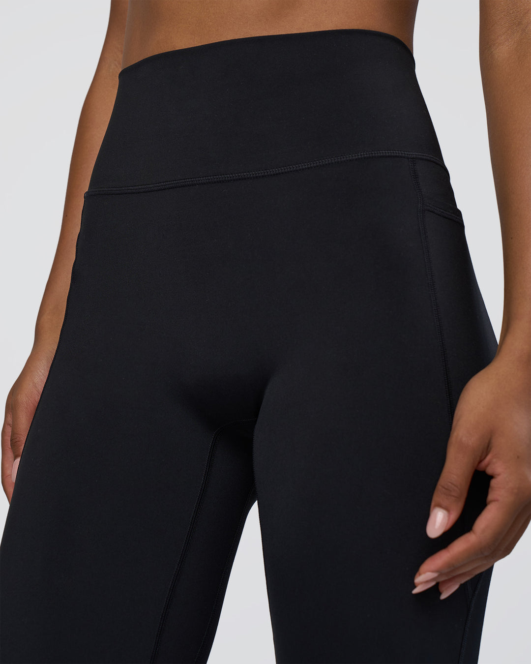 Woman wearing Fusion Ultra High-Rise Flared Tall Legging Pockets - Black | Model:Tomi | Size:S