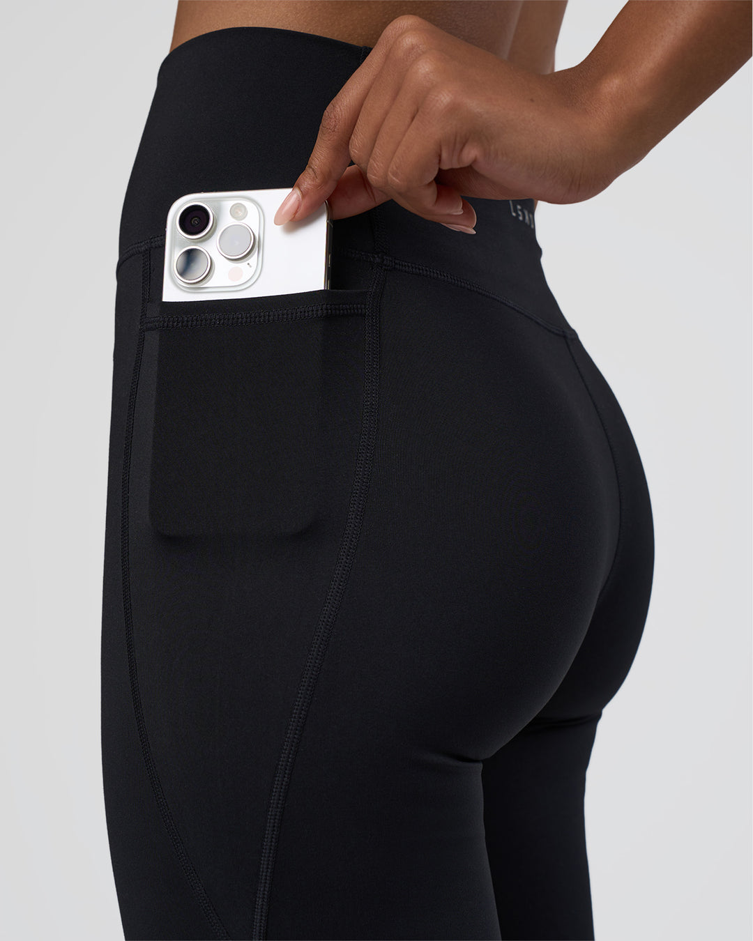 Woman wearing Fusion Ultra High-Rise Flared Tall Legging Pockets - Black | Model:Tomi | Size:S