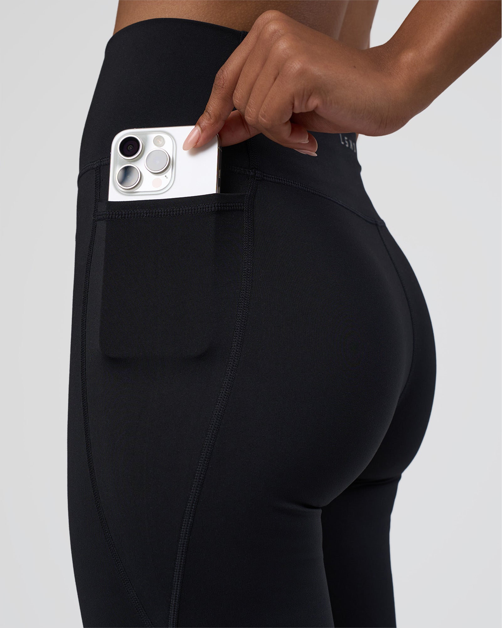 Woman wearing Fusion Ultra High-Rise Flared Tall Legging Pockets - Black | Model:Tomi | Size:S