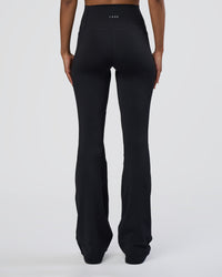 Woman wearing Fusion Ultra High-Rise Flared Tall Legging Pockets - Black | Model:Tomi | Size:S