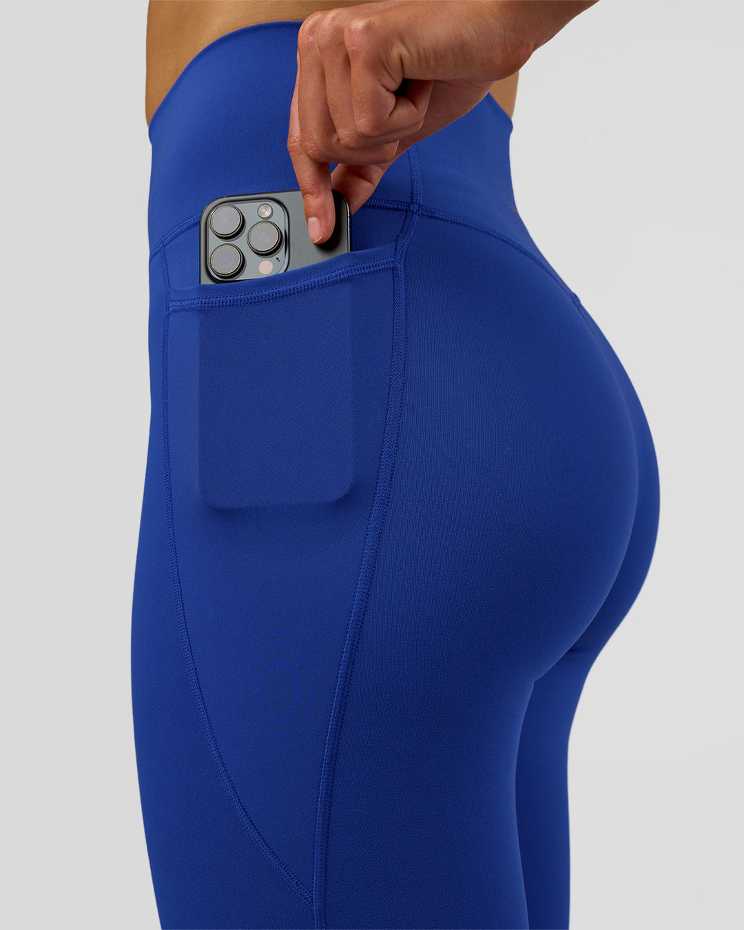Woman wearing Fusion Ultra High-Rise Full Length Legging Pockets - Electric Indigo | Model:Evie | Size:S