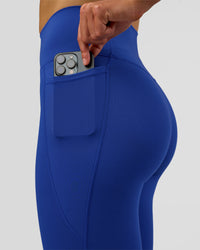 Woman wearing Fusion Ultra High-Rise Full Length Legging Pockets - Electric Indigo | Model:Evie | Size:S