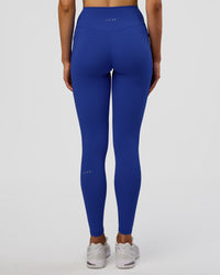 Woman wearing Fusion Ultra High-Rise Full Length Legging Pockets - Electric Indigo | Model:Evie | Size:S