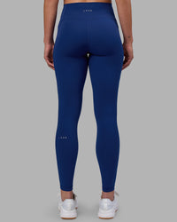 Woman wearing Fusion Ultra High-Rise Full Length Legging Pockets - Midnight Blue | Model:Charlize | Size:S
