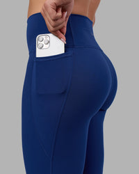 Woman wearing Fusion Ultra High-Rise Full Length Legging Pockets - Midnight Blue | Model:Charlize | Size:S