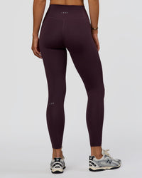 Woman wearing Fusion Ultra High-Rise Full Length Legging Pockets - Midnight Plum | Model:Amity | Size:S