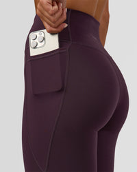 Woman wearing Fusion Ultra High-Rise Full Length Legging Pockets - Midnight Plum | Model:Amity | Size:S