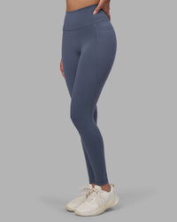 Woman wearing Fusion Ultra High-Rise Full Length Legging Pockets - Night Shadow | Model:Rhiley | Size:S