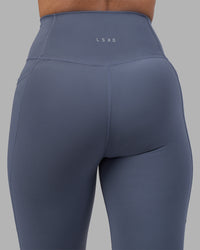Woman wearing Fusion Ultra High-Rise Full Length Legging Pockets - Night Shadow | Model:Rhiley | Size:S
