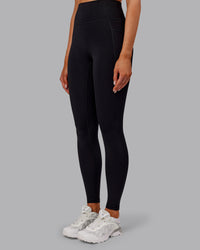 Woman wearing Fusion Ultra High-Rise Full Length Thermal Legging Pockets - Black | Model:Ella | Size:S