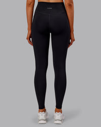 Woman wearing Fusion Ultra High-Rise Full Length Thermal Legging Pockets - Black | Model:Ella | Size:S