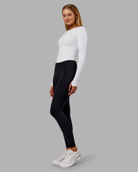 Woman wearing Fusion Ultra High-Rise Full Length Thermal Legging Pockets - Black | Model:Ella | Size:S