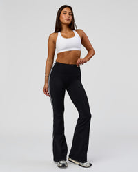 Woman wearing Fusion V-Contour Bind High-Rise Flared Legging - Black-white | Model:Bianca | Size:S
