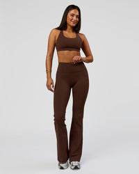 Woman wearing Fusion V-Contour Bind High-Rise Flared Legging - Hot Chocolate-white | Model:Bianca | Size:S