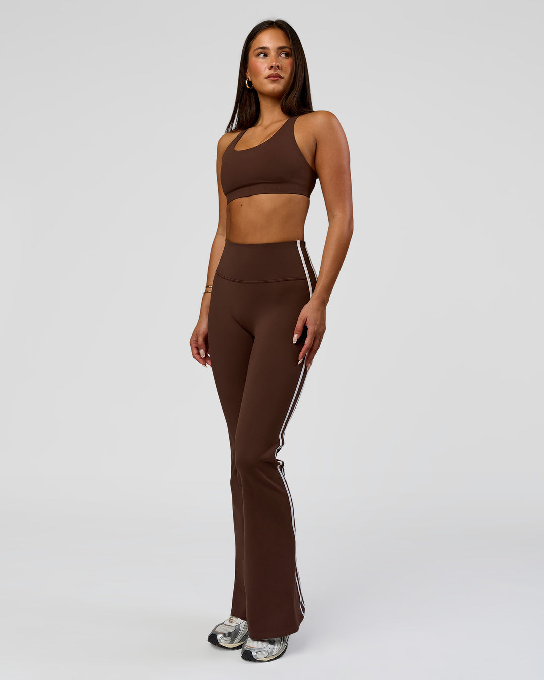 Woman wearing Fusion V-Contour Bind High-Rise Flared Legging - Hot Chocolate-white | Model:Bianca | Size:S