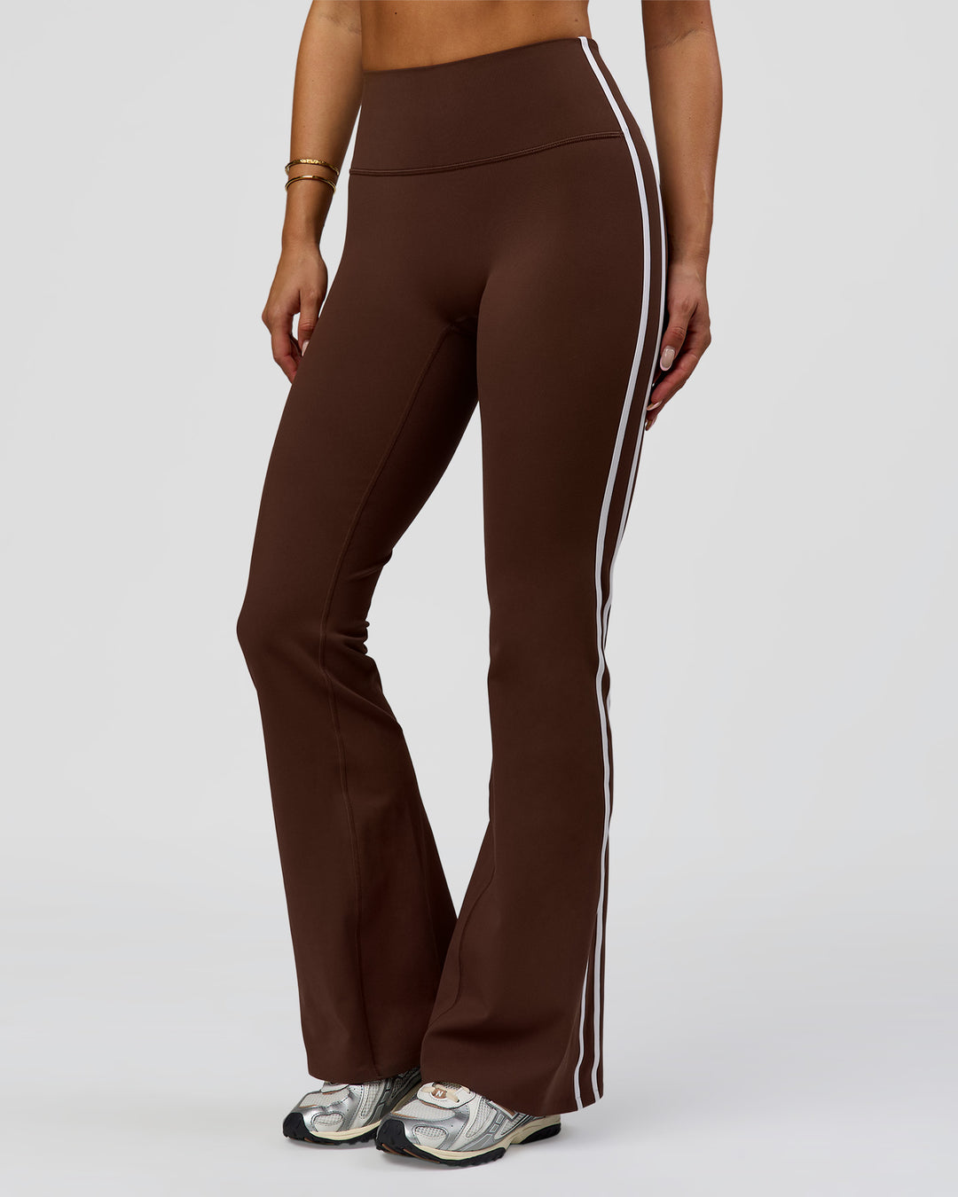 Woman wearing Fusion V-Contour Bind High-Rise Flared Legging - Hot Chocolate-white | Model:Bianca | Size:S