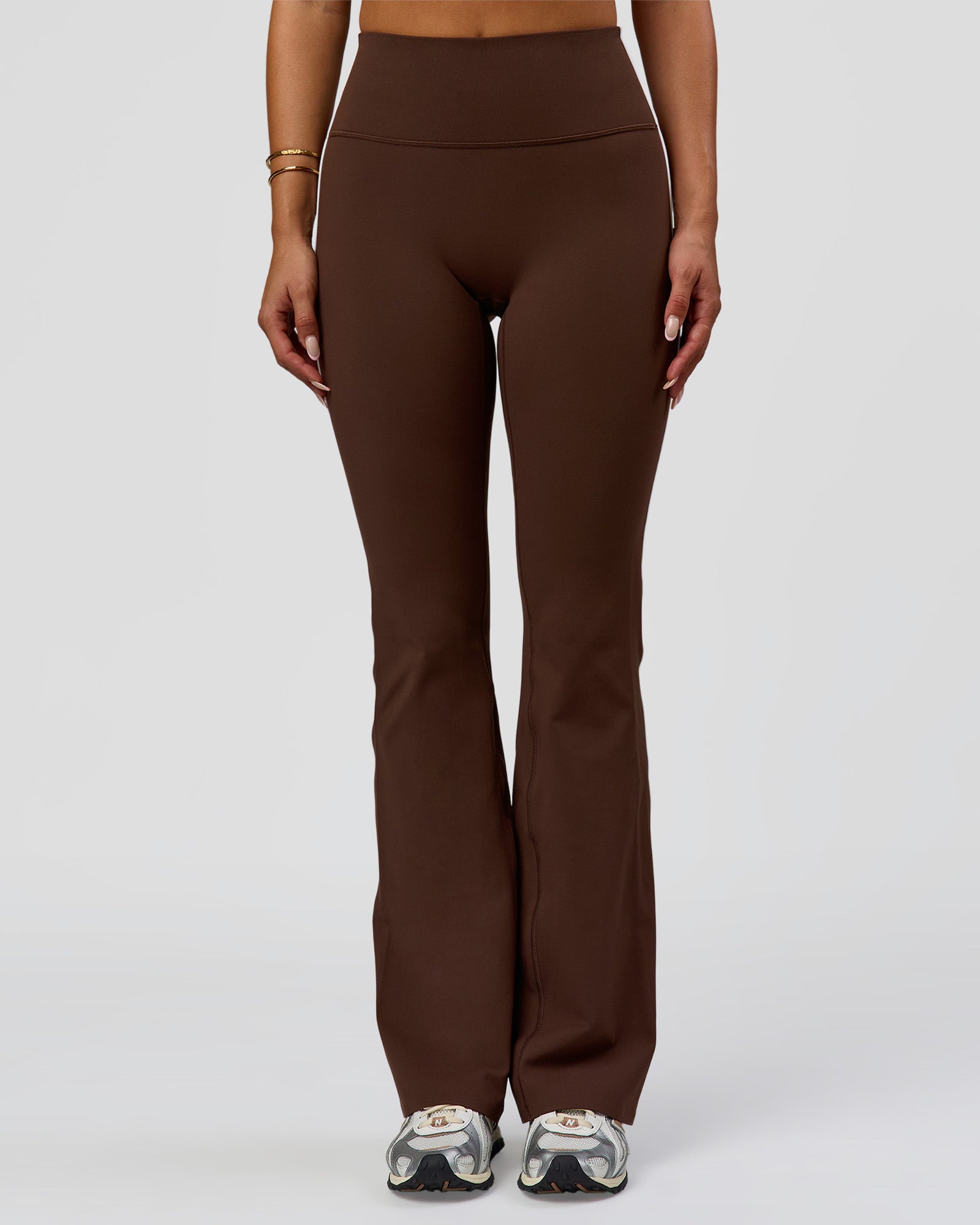 Woman wearing Fusion V-Contour Bind High-Rise Flared Legging - Hot Chocolate-white | Model:Bianca | Size:S