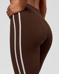 Woman wearing Fusion V-Contour Bind High-Rise Flared Legging - Hot Chocolate-white | Model:Bianca | Size:S