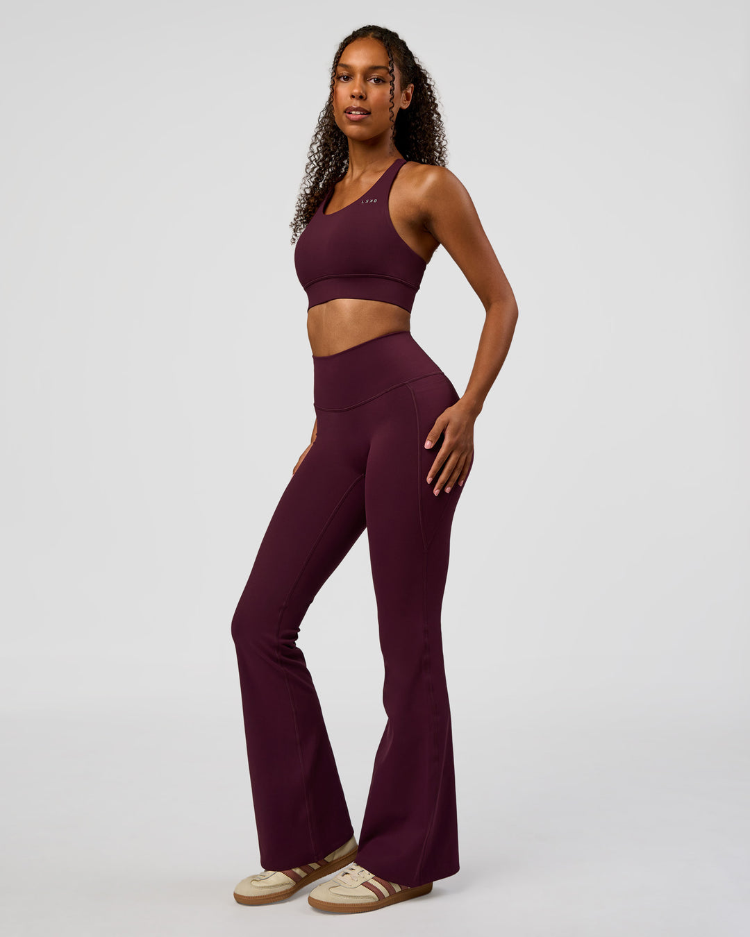 Woman wearing Fusion V-Contour High-Rise Flared Legging Pockets - Cherry Lacquer | Model:Jordan | Size:S