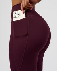 Woman wearing Fusion V-Contour High-Rise Flared Legging Pockets - Cherry Lacquer | Model:Jordan | Size:S