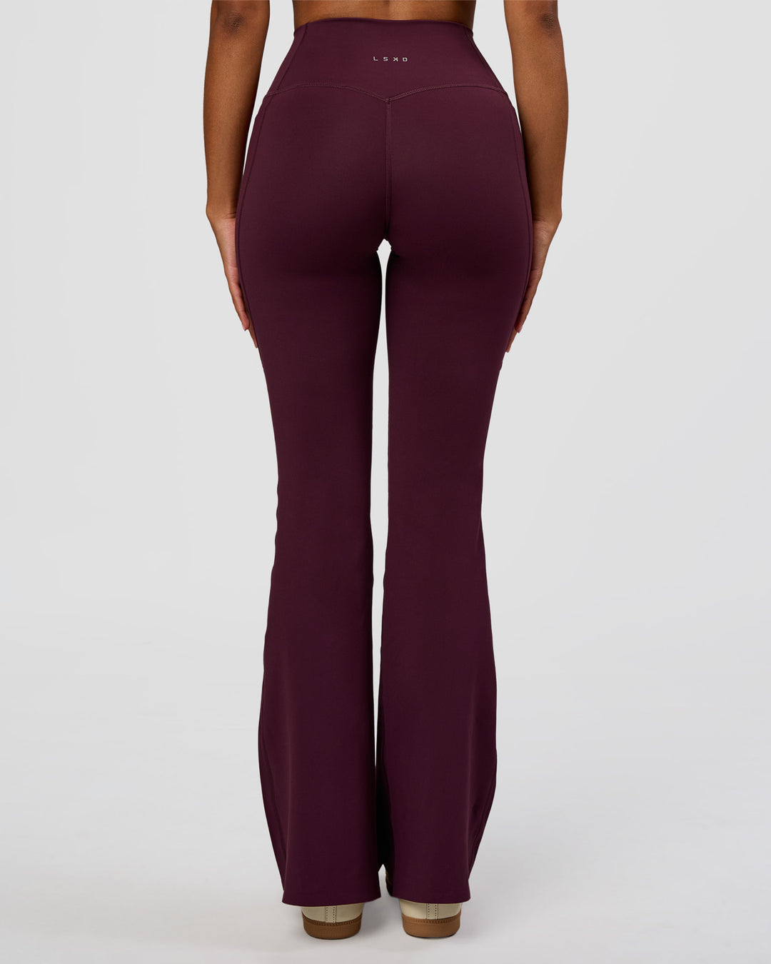 Woman wearing Fusion V-Contour High-Rise Flared Legging Pockets - Cherry Lacquer | Model:Jordan | Size:S