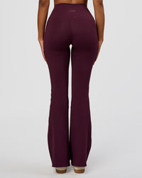 Woman wearing Fusion V-Contour High-Rise Flared Legging Pockets - Cherry Lacquer | Model:Jordan | Size:S