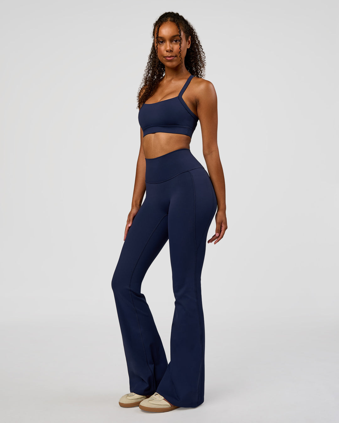 Woman wearing Fusion V-Contour High-Rise Flared Legging Pockets - Future Navy | Model:Jordan | Size:S