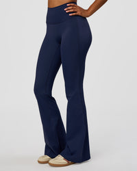 Woman wearing Fusion V-Contour High-Rise Flared Legging Pockets - Future Navy | Model:Jordan | Size:S